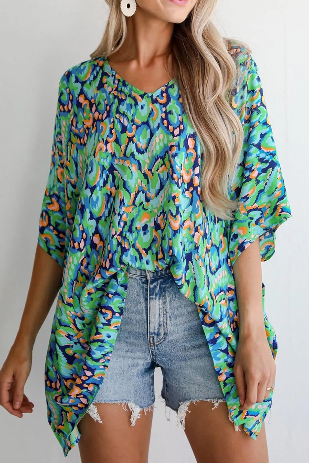 Front view of Abstract Print V Neck Half Sleeve Loose Fit Blouse in Turquoise showing neckline and sleeve details