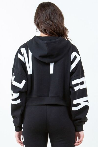 Front view of American Bazi Letter Graphic Long Sleeve Drawstring Cropped Hoodie in Black showing neckline and sleeve details