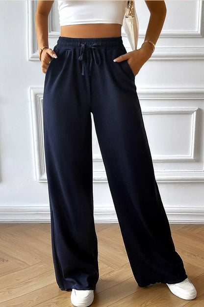Front view of Devine Drawstring Wide Leg Pants with Pocketed in Dark Blue showing neckline and sleeve details