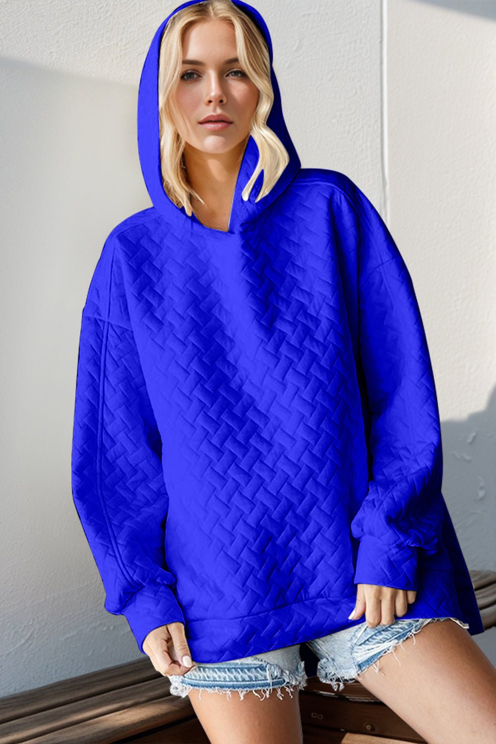 Front view of Double Take Full Size Texture Drop Shoulder Long Sleeve Hoodie in Royal Blue showing neckline and sleeve detail