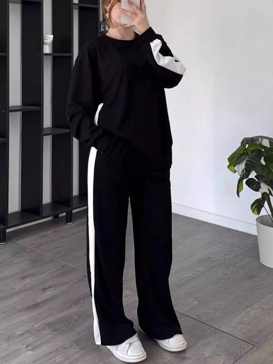 Front view of Full Size Contrast Round Neck Top and Pants Set Plus Size in Black showing neckline and sleeve details