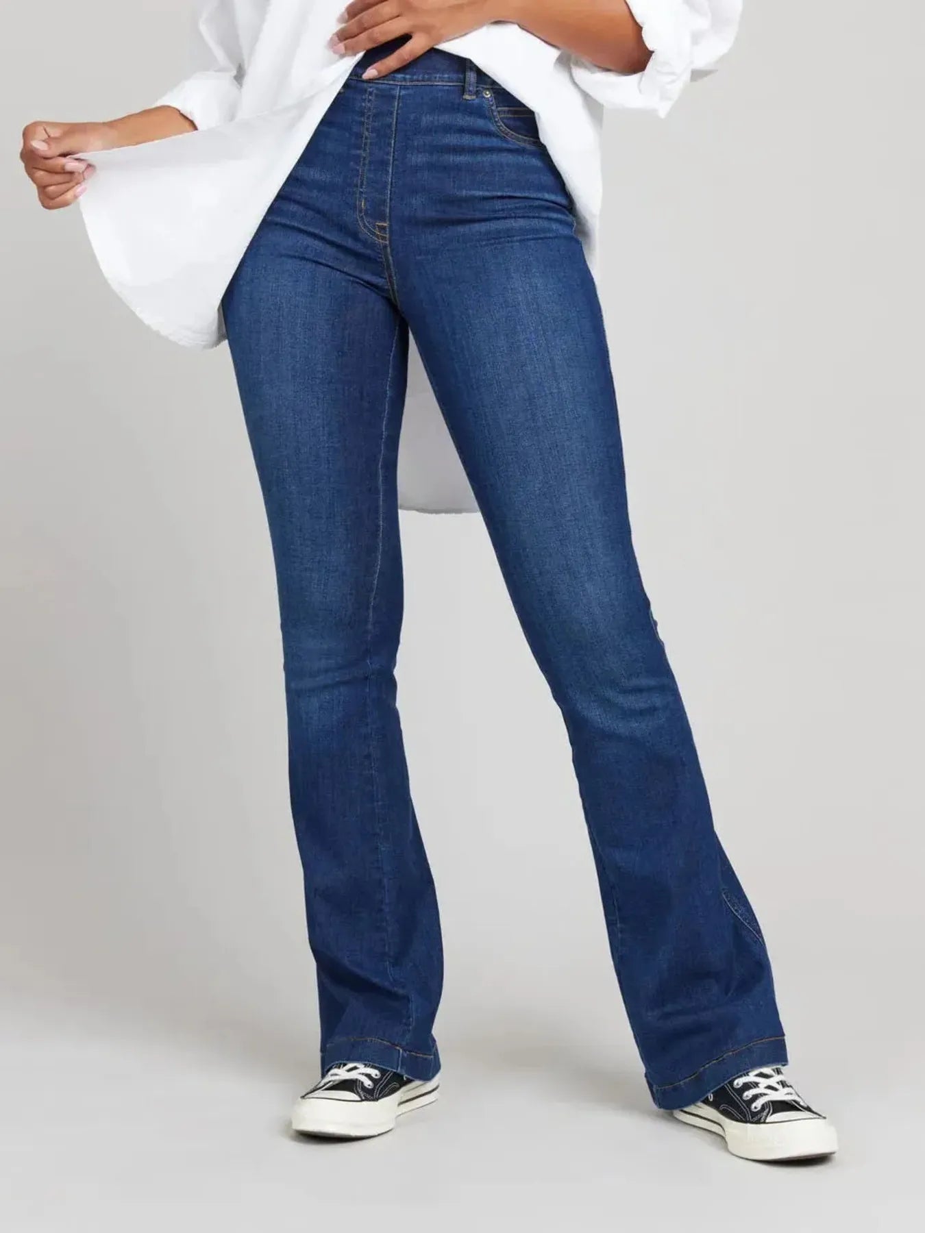 Front view of Full Size High-Waisted Flare Jeans Plus Size in Dark Blue showing neckline and sleeve details