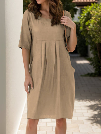 Front view of Full Size Round Neck Half Sleeve Dress with Pockets in Tan showing neckline and sleeve details (100% polyester)