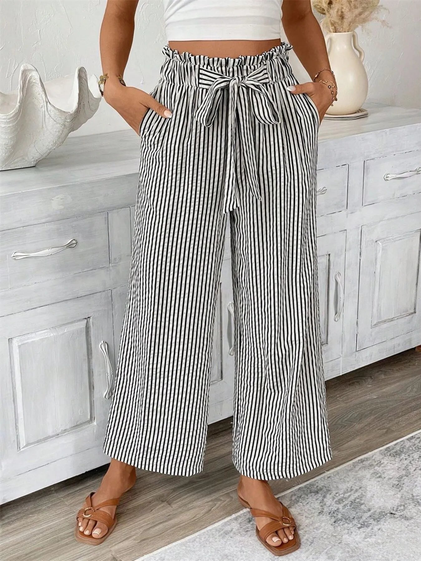 Front view of Full Size Striped Wide Leg Paper Bag Pants Plus Size in Black showing neckline and sleeve details