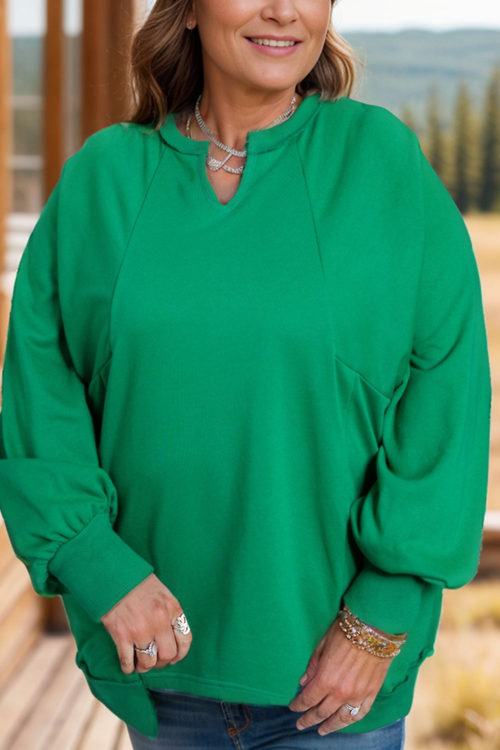 Front view of Plus Size Cutout Hem Notched Long Sleeve Sweatshirt in Dark Green showing neckline and sleeve details