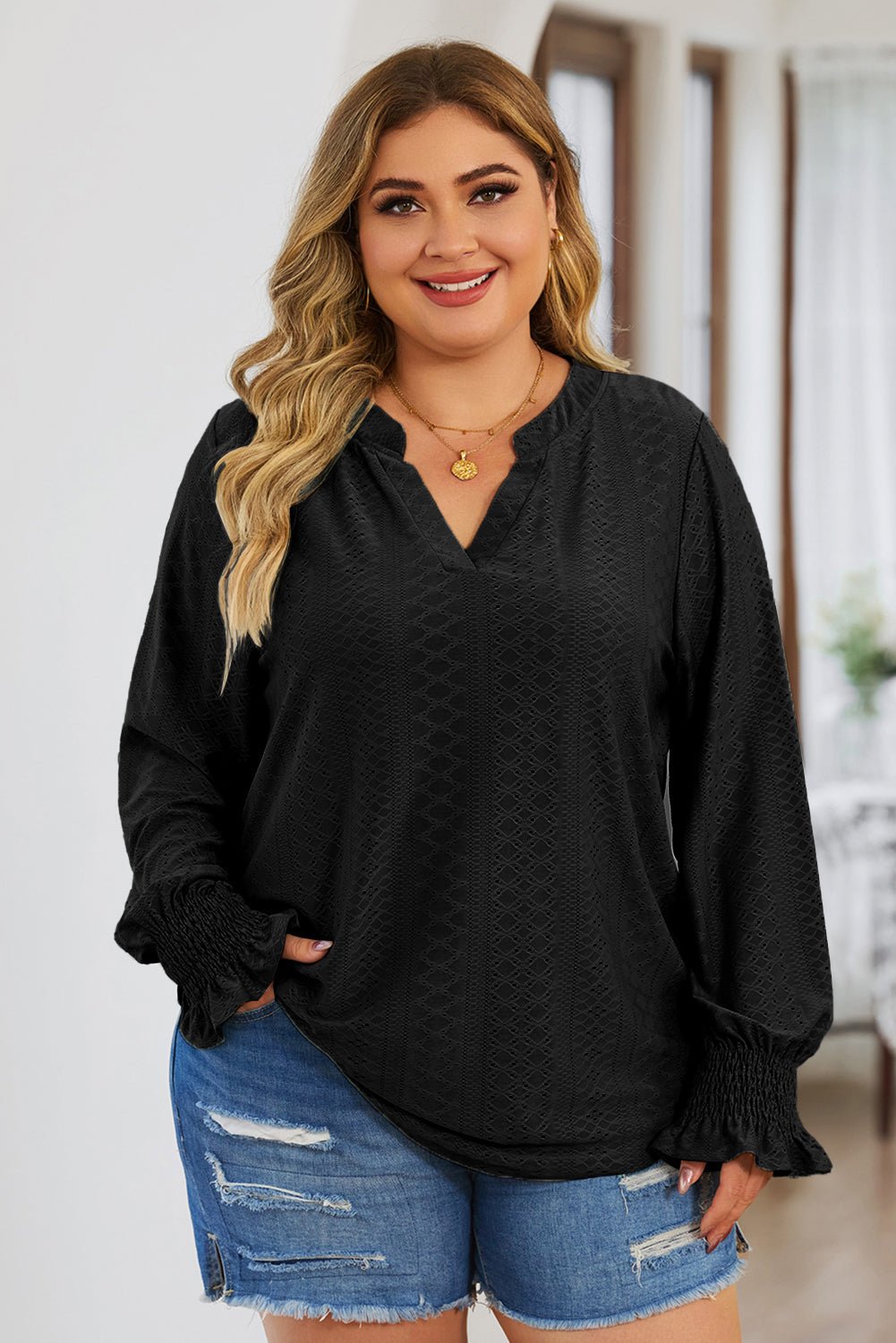 Front view of Plus Size Eyelet Notched Flounce Sleeve Blouse in Black showing neckline and sleeve details