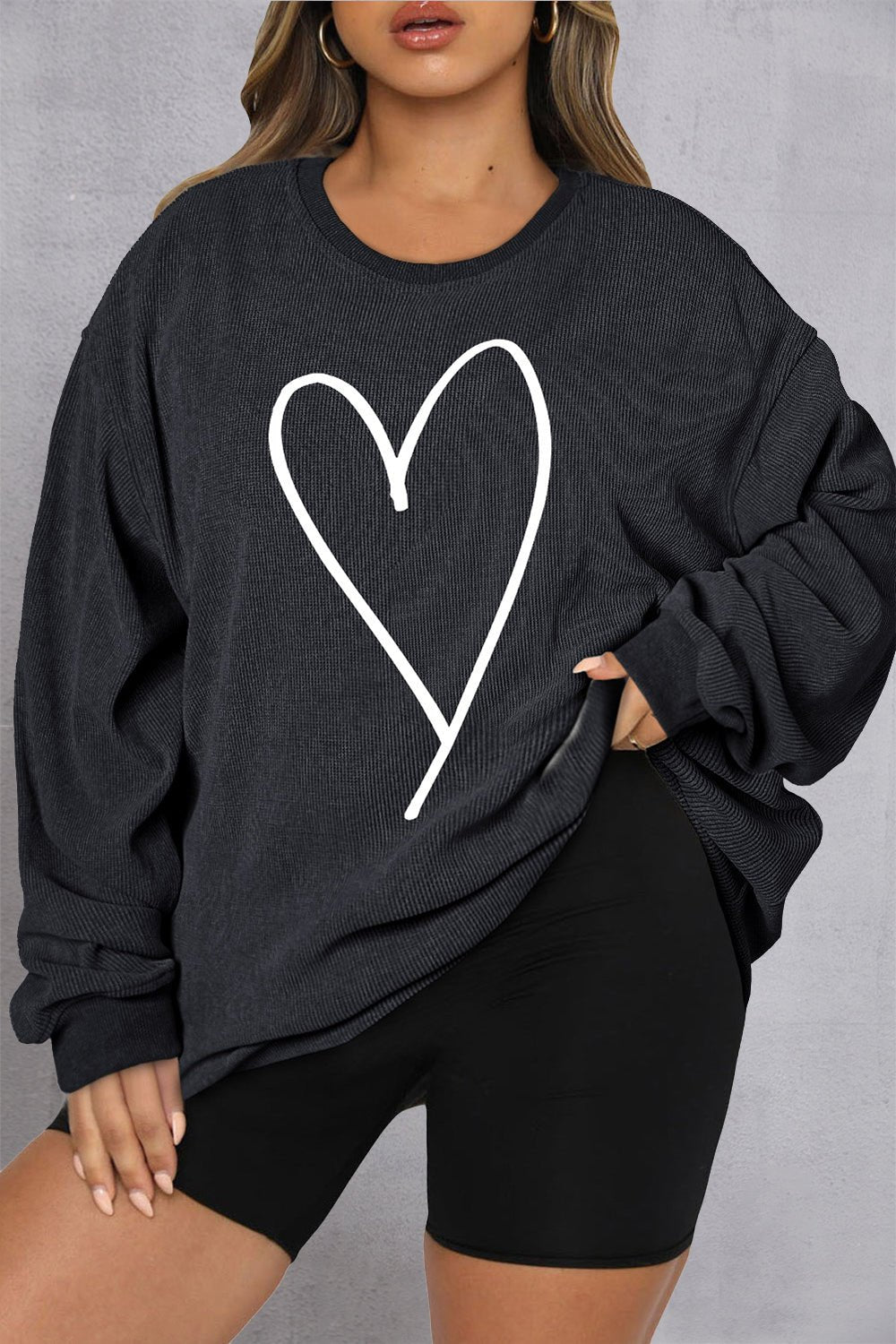 Front view of Plus Size Heart Ribbed Round Neck Sweatshirt in Black showing neckline and sleeve details