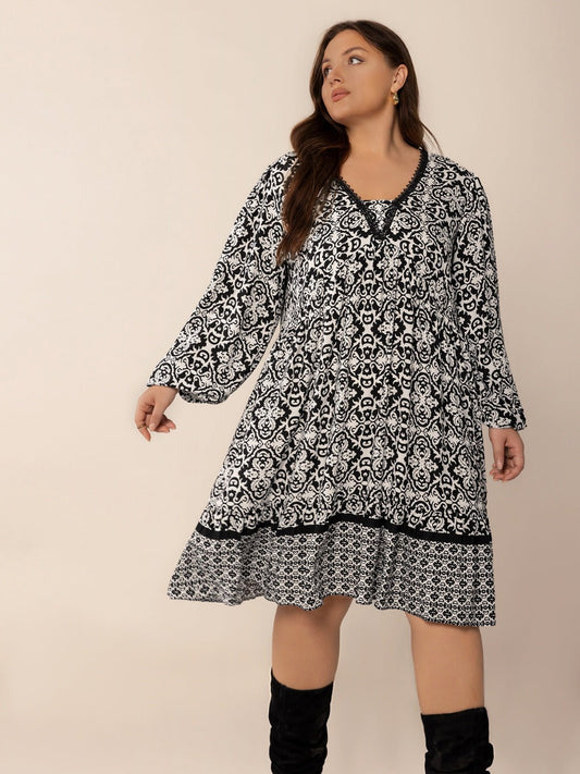 Front view of Plus Size Lace Detail Printed Balloon Sleeve Dress in Black showing neckline and sleeve details