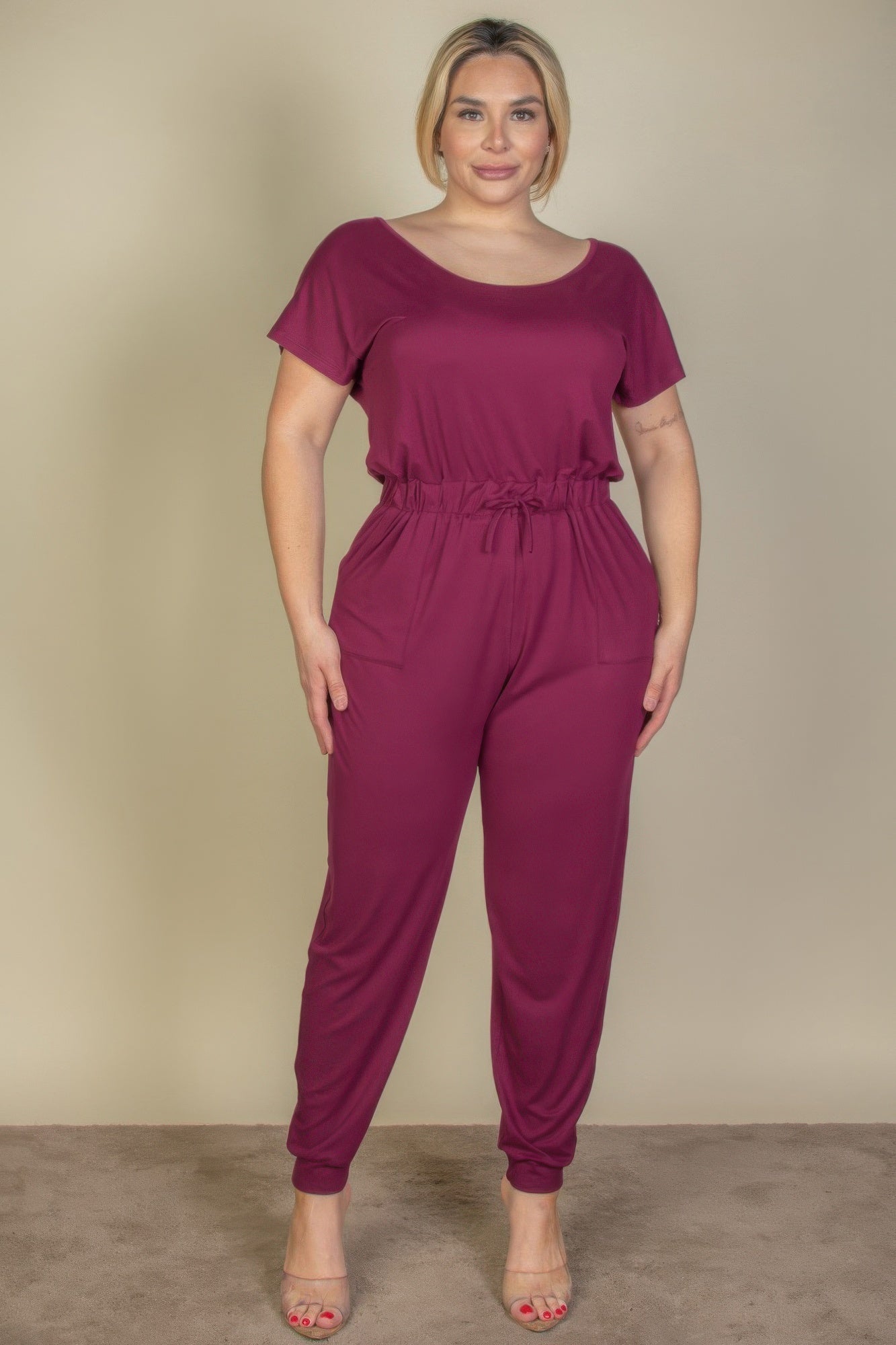 Front view of Plus Size Solid Drawstring Short Sleeve Jumpsuit showing neckline and sleeve details