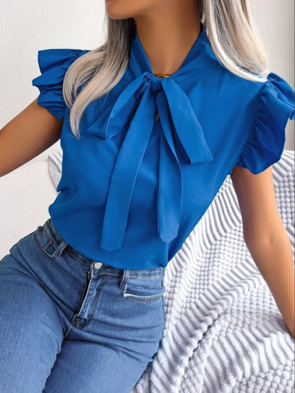 Front view of Ruffle Cap Sleeve Bow Tie Blouse in Blue showing neckline and sleeve details (100% polyester Care instructions)