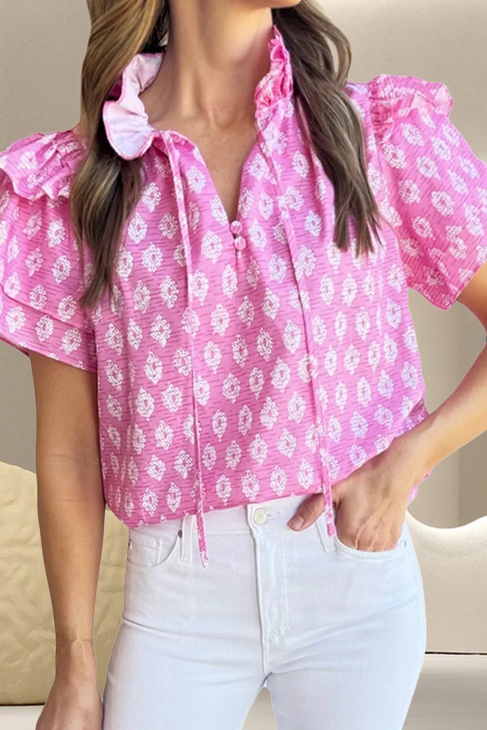 Front view of Ruffled Printed Tie Neck Short Sleeve Blouse in Fuchsia Pink showing neckline and sleeve details