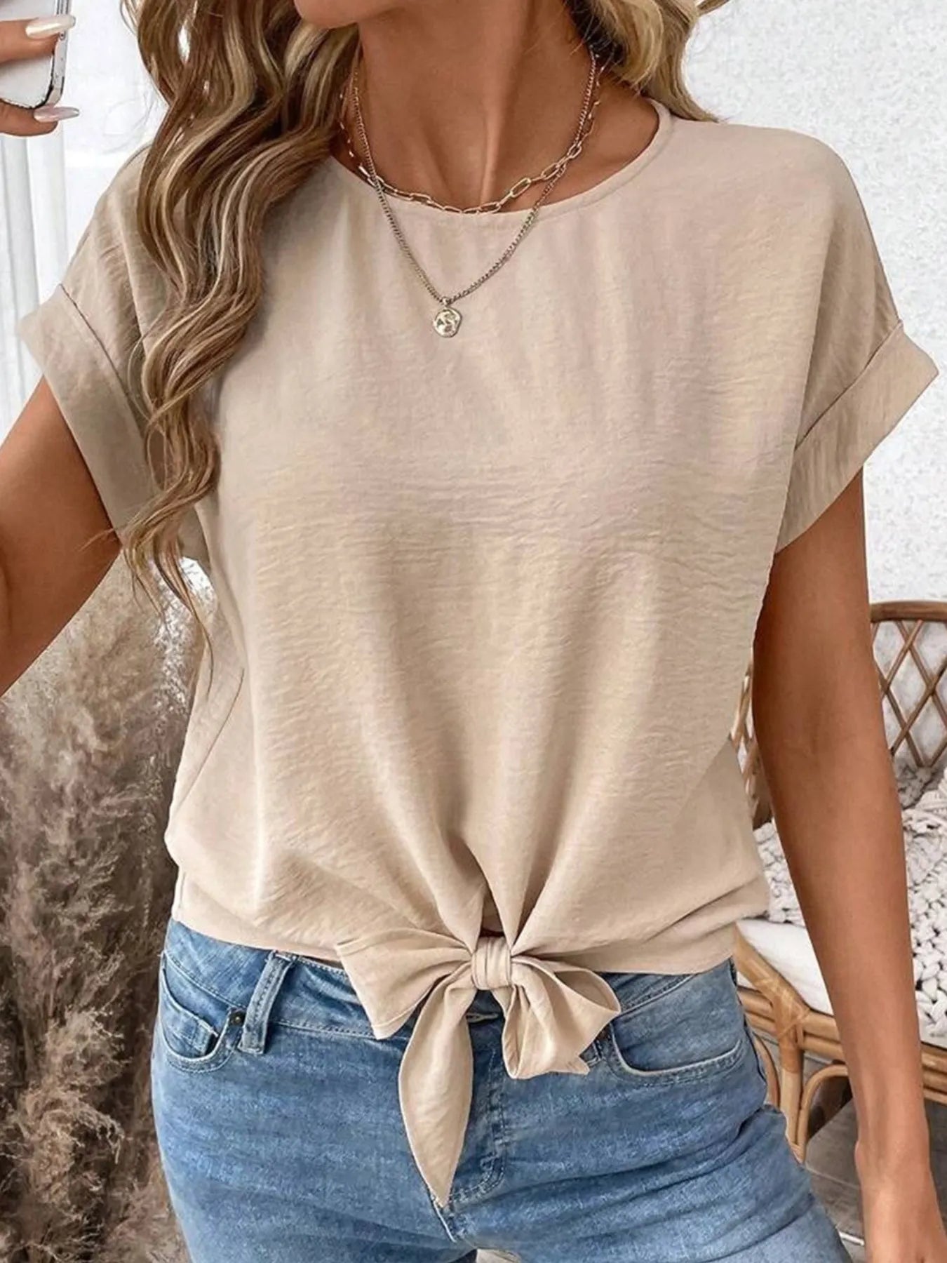 Front view of Solid Color Knotted Hem Short Sleeve Blouse in Beige showing neckline and sleeve details
