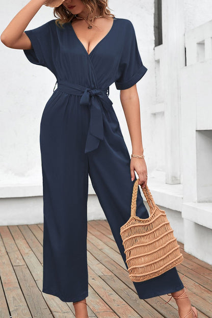 Front view of Tie Waist Surplice Wide Leg Jumpsuit in Navy showing neckline and sleeve details (95% polyester and)